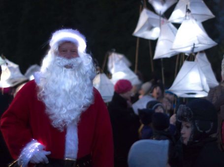 Father Christmas and local school children holding lanterns at the Warlingham Christmas Party Event in Warlingham, Surrey